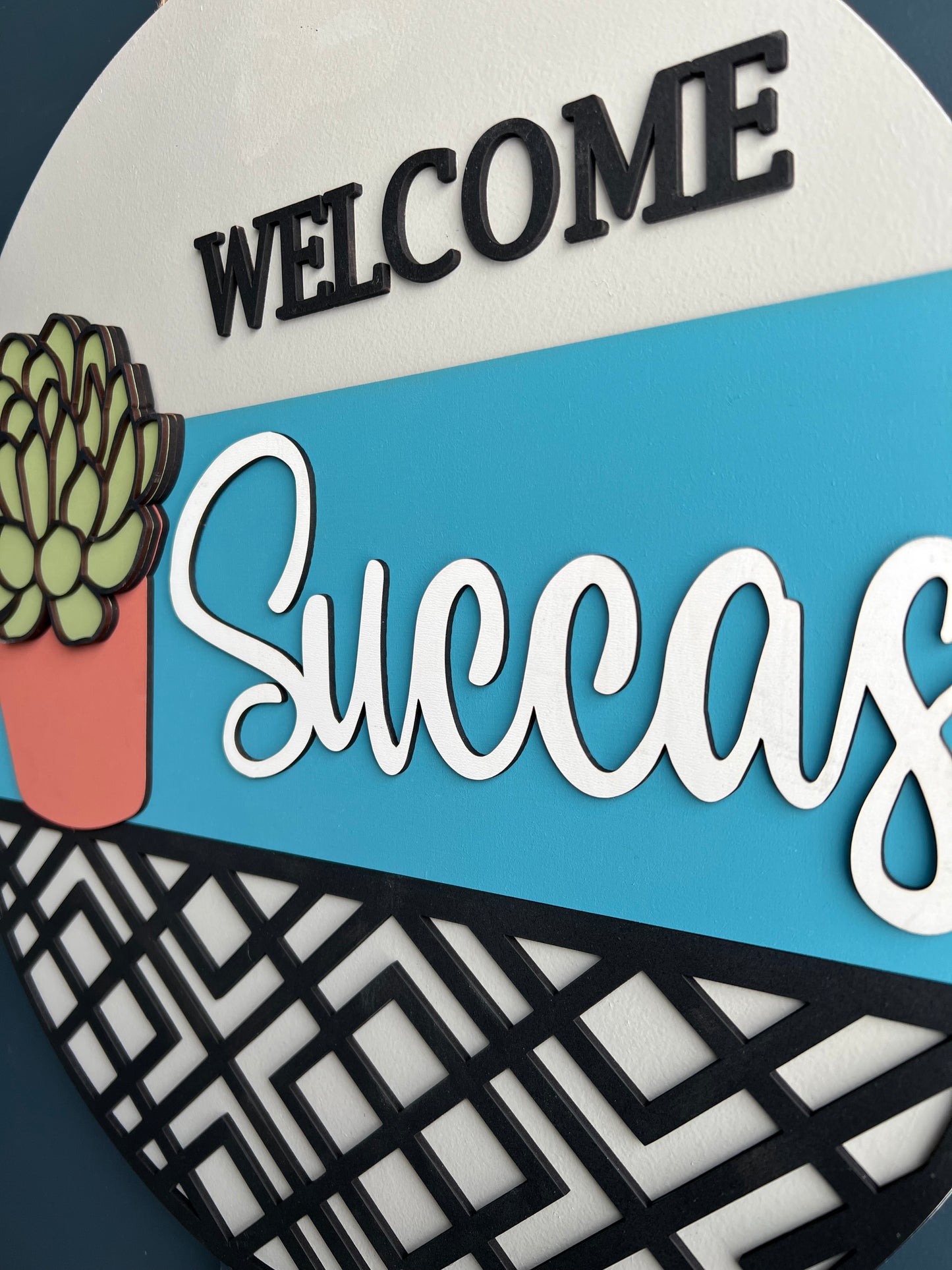 "Welcome Succas" Round Sign