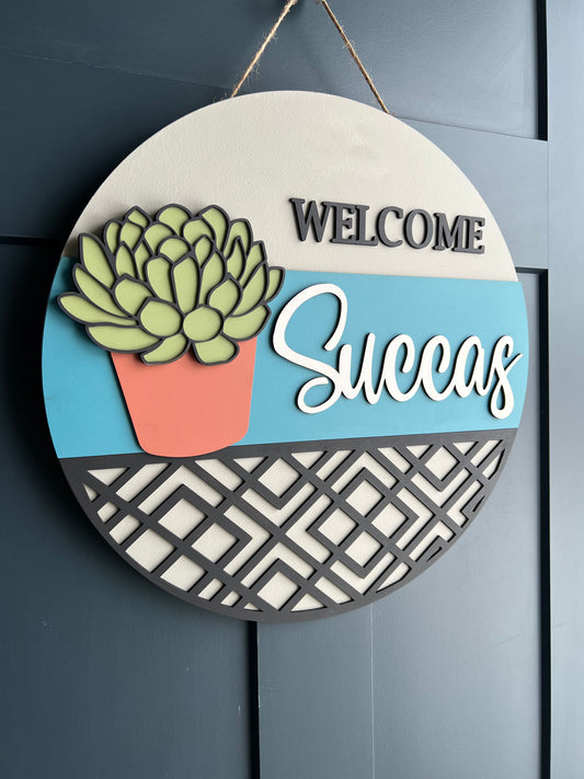 "Welcome Succas" Round Sign